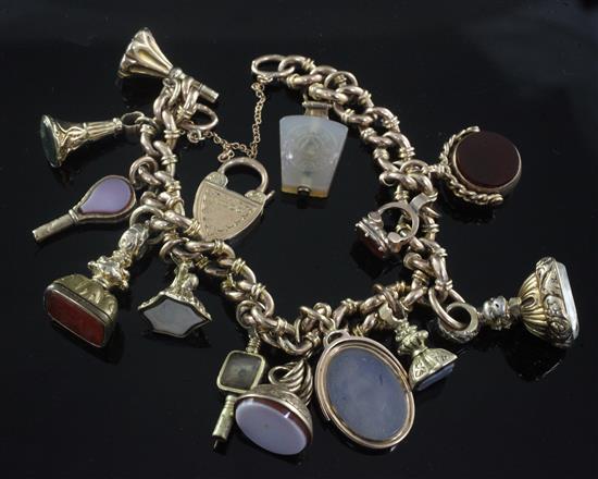 An early 20th century 9ct gold charm bracelet,